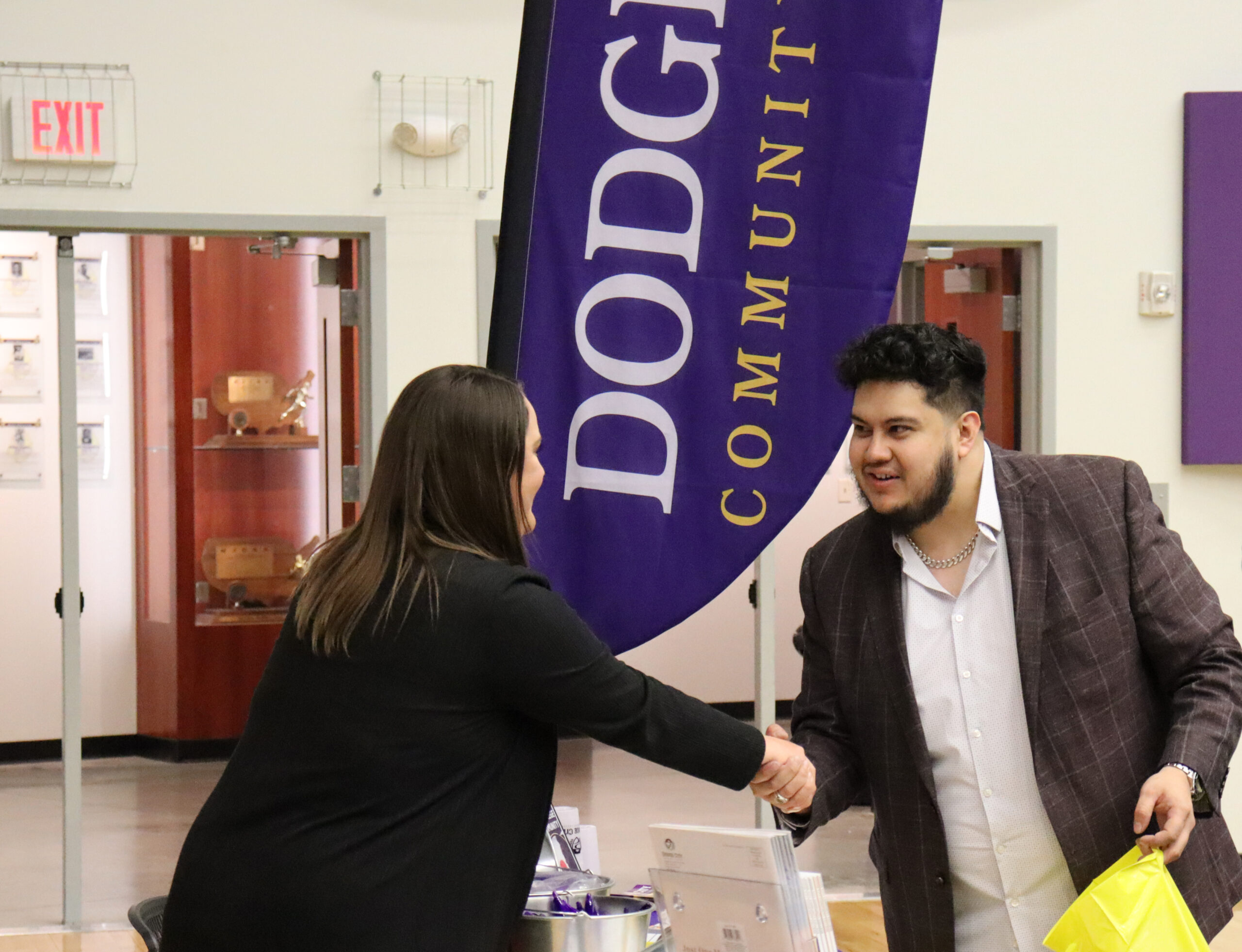 Kristi Ohlschwager, DC3 Assistant Vice President of Administration and Human Resources, shakes hands with Jesus Bautista Lara, who is the manager of Riddle’s Jewelry, during the Bid Process Expo on Tuesday, April 5. [Photo by Luke Fay]