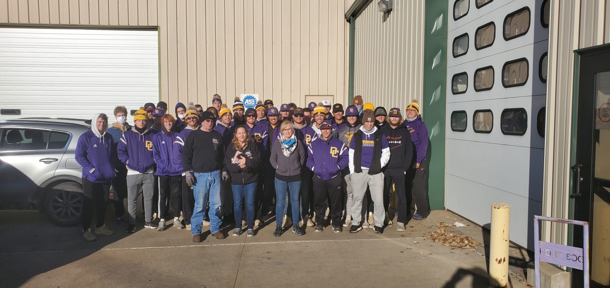 Charlotte Neuschafer, Director of Ford County RSVP and the Child and Adult Care Food Program, the DC3 Baseball team, and volunteers pose for a group photo